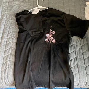 Black tee with flower design, never worn